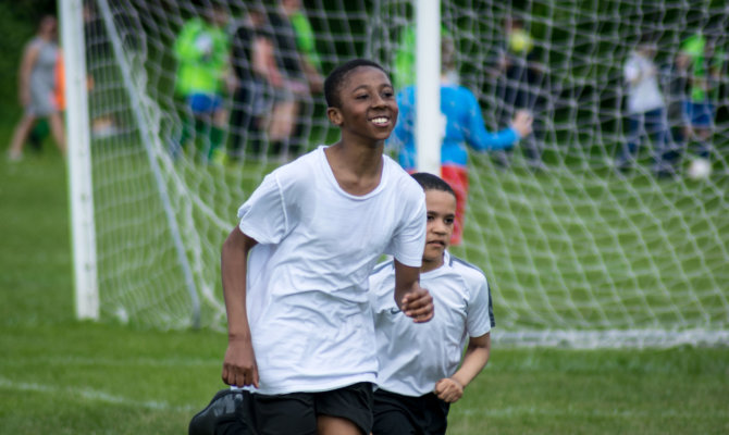 Boys running in a London playing field