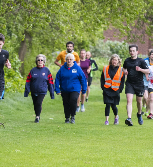 Donate - people running at peter May Sports Ground