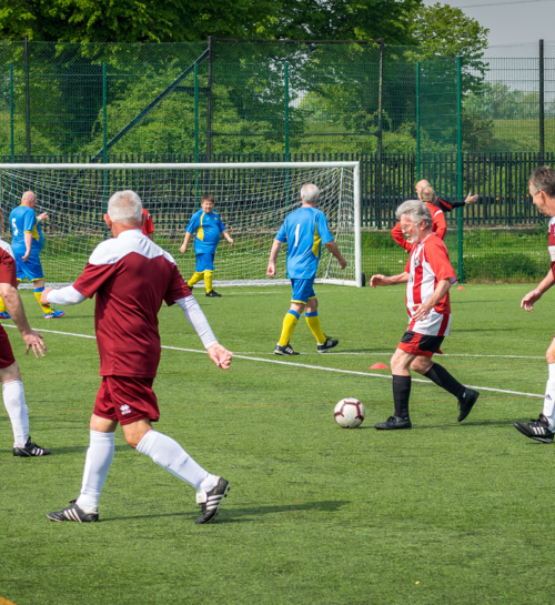 Mature football players mid game