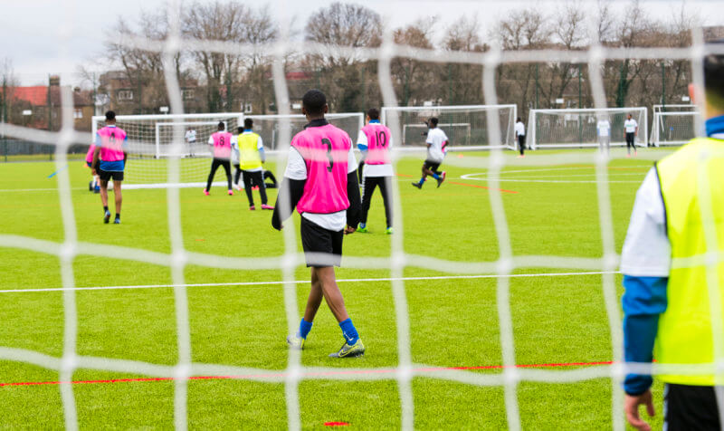 Looking through a goal at a football match