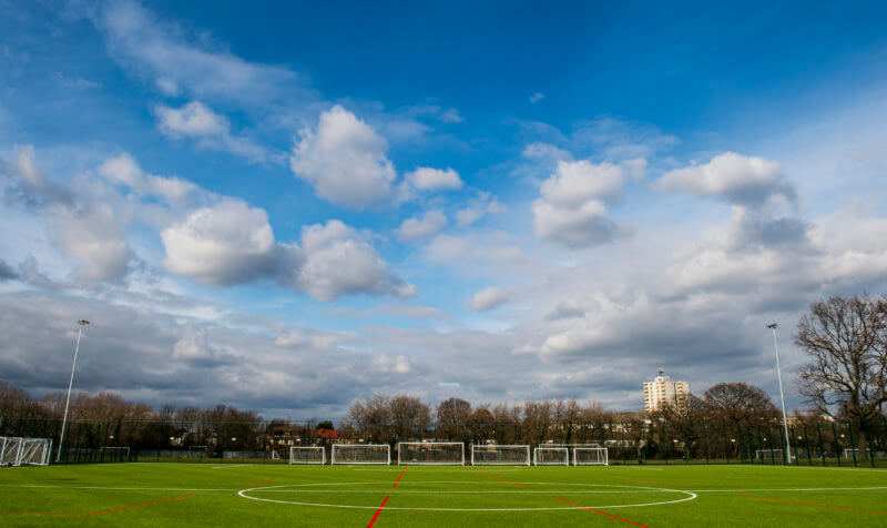 London playing field with blue sky