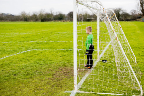 Young football player in goal