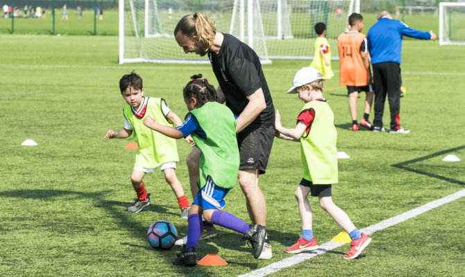 A coach encouraging young players