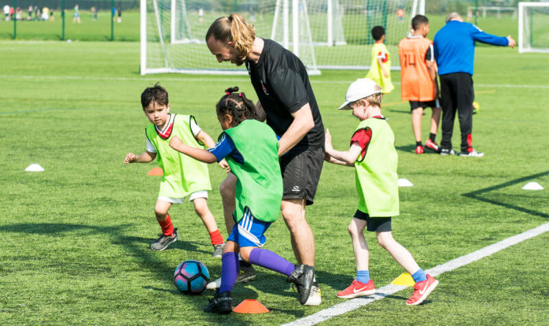 A coach encouraging young players