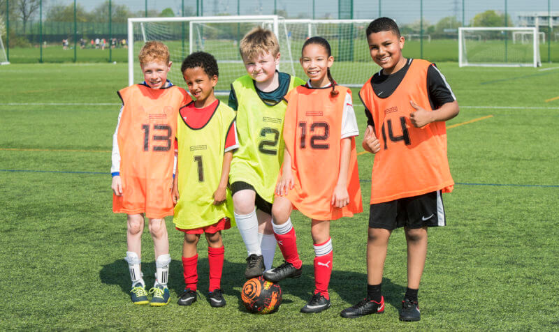 young players in numbered bibs